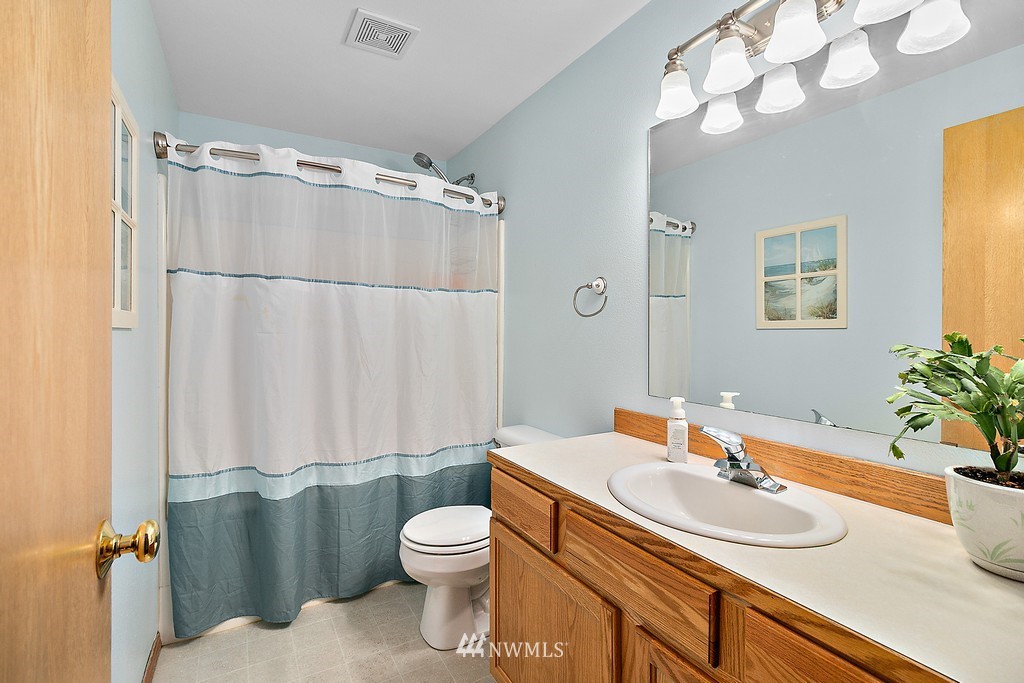5121 183rd Lane Southwest Rochester, WA 98579 - Photo 15 of 31 a bathroom with a sink vanity mirror and toilet