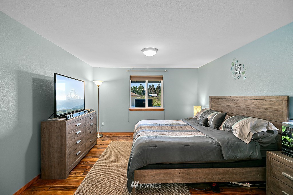 5121 183rd Lane Southwest Rochester, WA 98579 - Photo 20 of 31 a bedroom with a bed and a flat screen tv