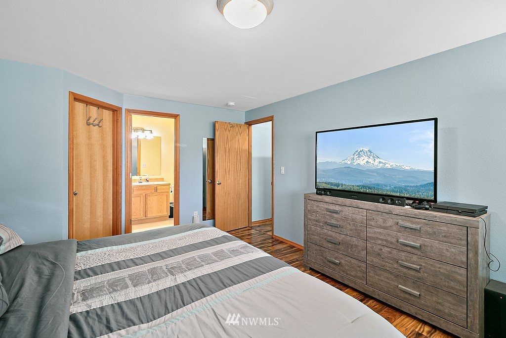 5121 183rd Lane Southwest Rochester, WA 98579 - Photo 21 of 31 a bedroom with a bed and flat screen tv
