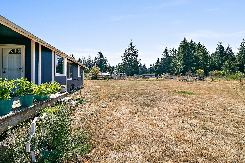 5121 183rd Lane Southwest Rochester, WA 98579 - Photo 31 of 31 a backyard of a house with lots of green space