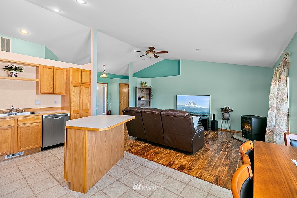 5121 183rd Lane Southwest Rochester, WA 98579 - Photo 5 of 31 a bedroom with a bed and a chandelier