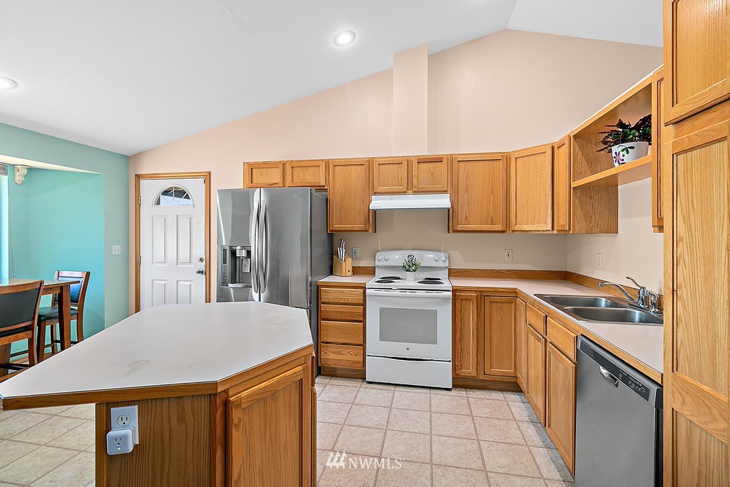 5121 183rd Lane Southwest Rochester, WA 98579 - Photo 6 of 31 a kitchen with cabinets and stainless steel appliances