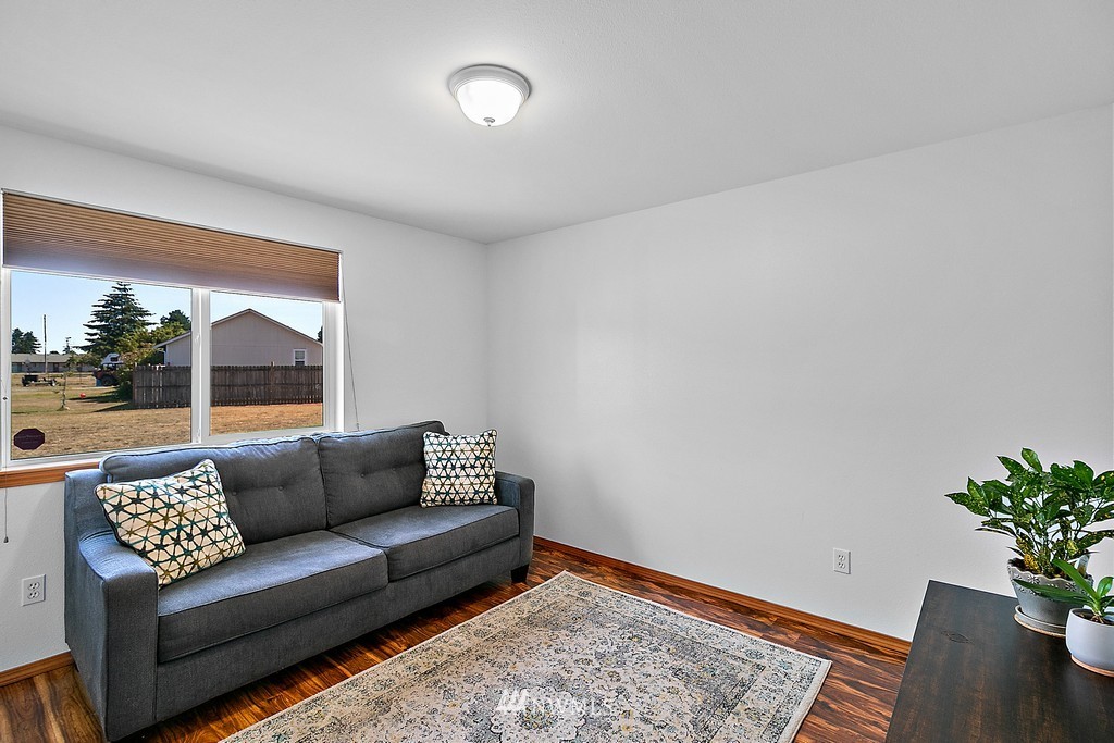 5121 183rd Lane Southwest Rochester, WA 98579 - Photo 9 of 31 a living room with furniture and a potted plant