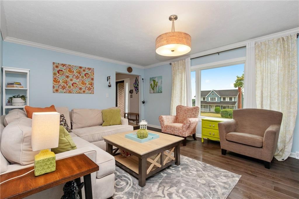 174 Cedar Ridge Drive Monaca, PA 15061 - Photo 2 of 22 Beautiful ash wood floors lend warmth to a formal living room while an over sized window frames outside views and gives way for abundant sunshine.
