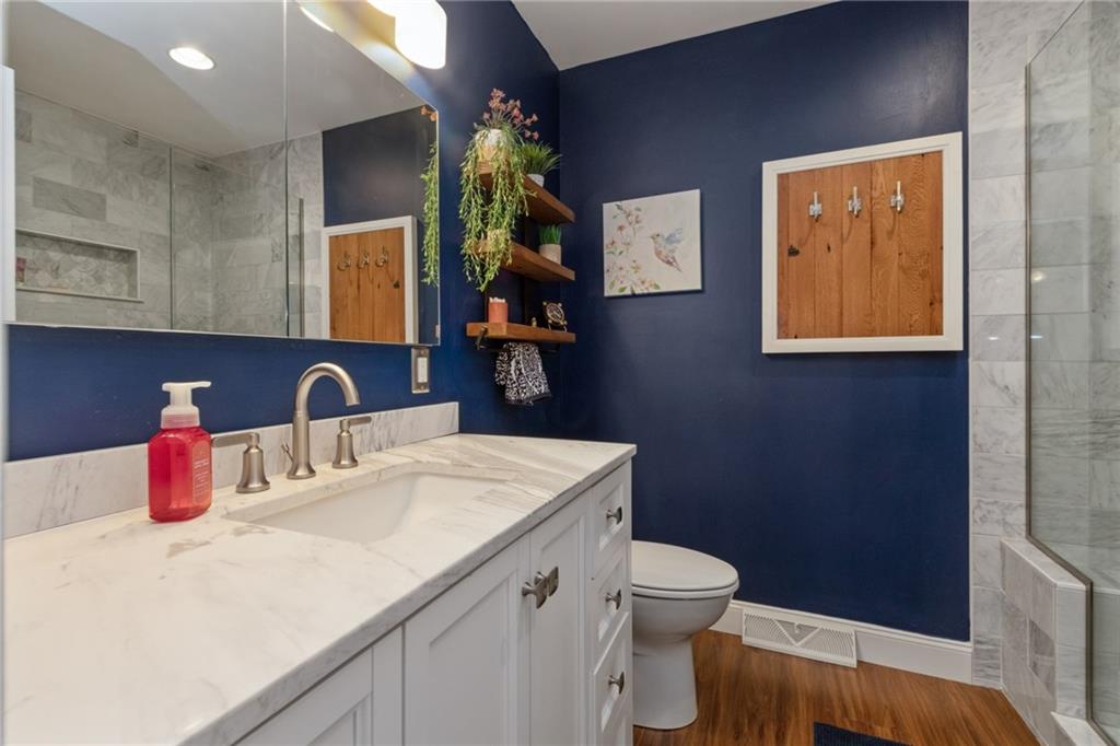 174 Cedar Ridge Drive Monaca, PA 15061 - Photo 13 of 22 A wonderful spa like master bath boasts a marble topped vanity and large marble tiled shower with seating.