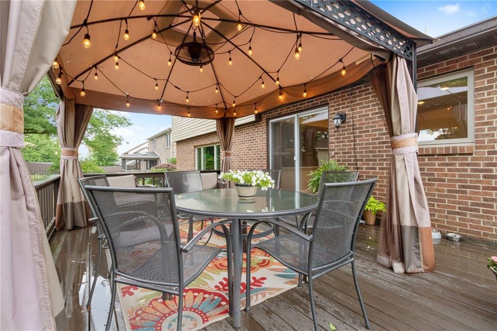 174 Cedar Ridge Drive Monaca, PA 15061 - Photo 19 of 22 A pergola with ceiling fan offers shelter from the sun or rain while string lighting adds laid back ambiance to the to the space.