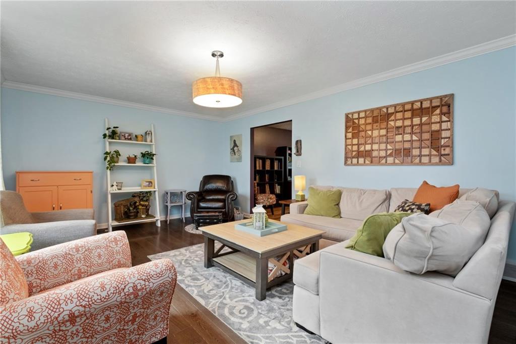 174 Cedar Ridge Drive Monaca, PA 15061 - Photo 3 of 22 Crisp white crown molding and chic lighting add classic style to the living room.