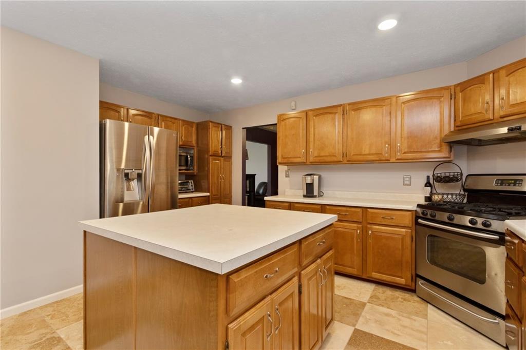 174 Cedar Ridge Drive Monaca, PA 15061 - Photo 5 of 22 Counter space is never a problem in the spacious eat-in-kitchen where a 4X4 island lends tons of space for party spreads.