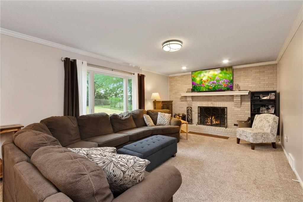 174 Cedar Ridge Drive Monaca, PA 15061 - Photo 8 of 22 The main floor family room is warmed by a classic neutral brick fireplace a large window invites rear yard views and tons of light.
