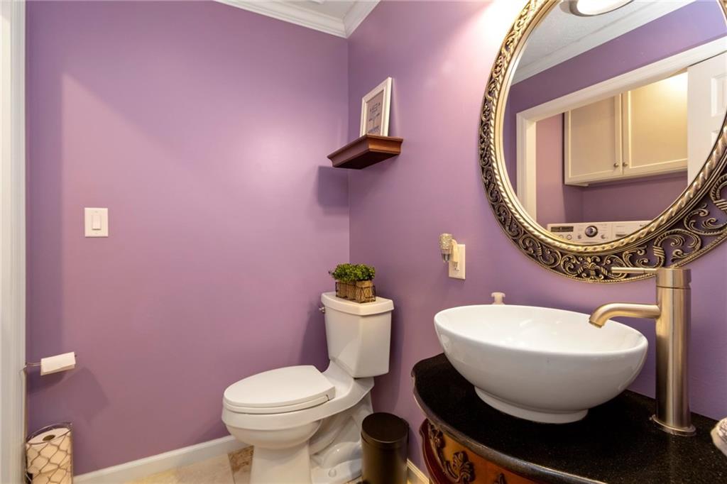 174 Cedar Ridge Drive Monaca, PA 15061 - Photo 10 of 22 A trendy vessel sink, natural stone flooring and crown molding lend class to the main floor powder room.