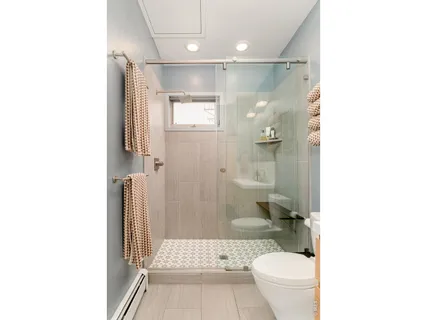 a bathroom with a toilet and a shower