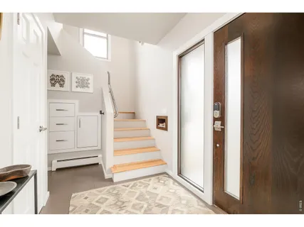 a view of entryway with white walls and stairs