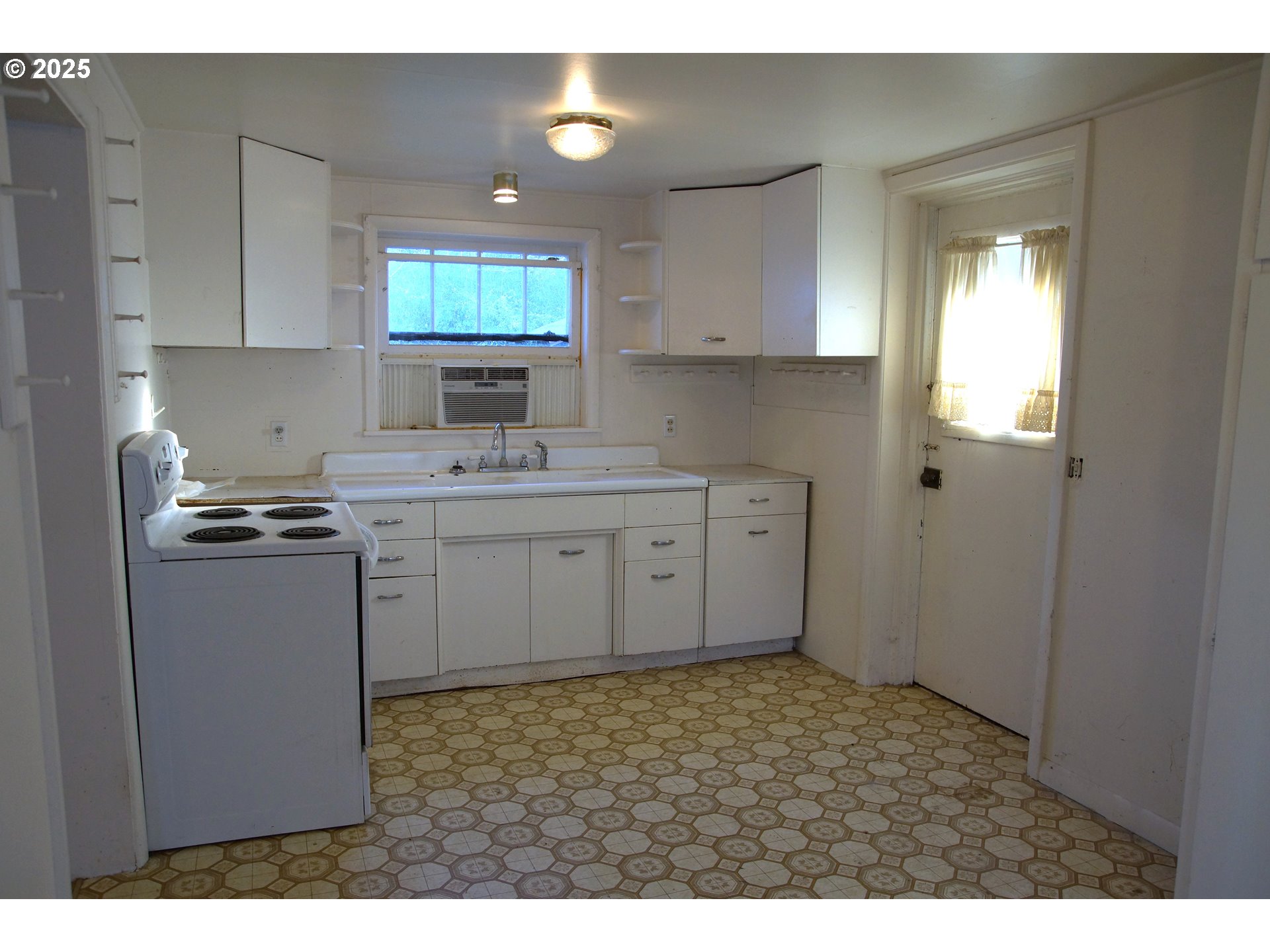 155 Driver Valley Road Oakland, OR 97462 - Photo 8 of 15 a kitchen with a sink cabinets and window