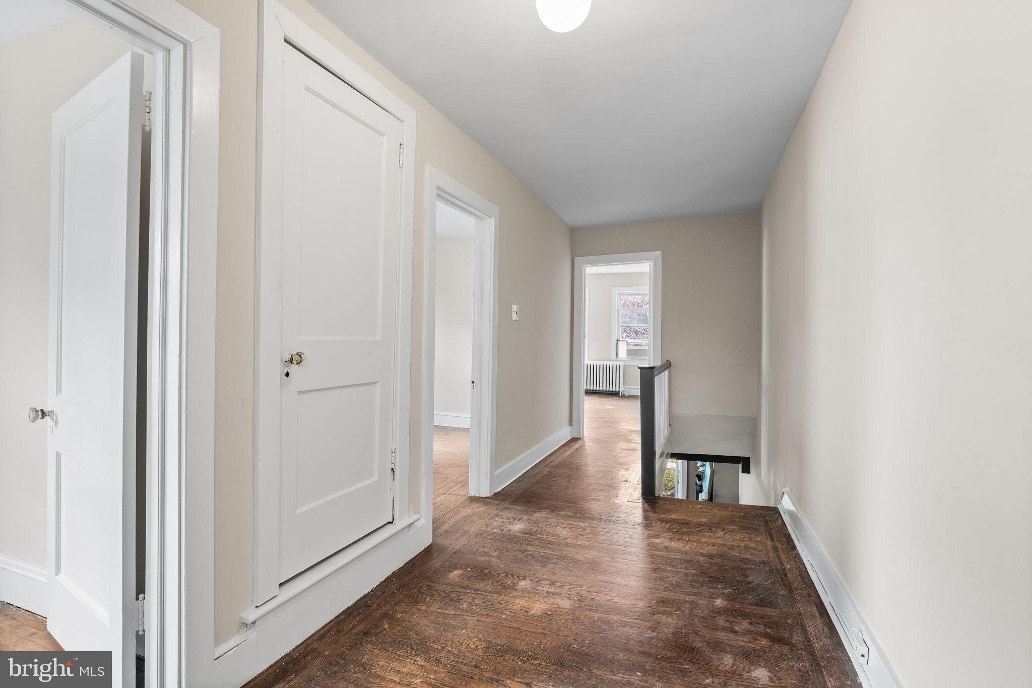96 Drexel Avenue Lansdowne, PA 19050 - Photo 21 of 58 a view of a hallway with wooden floor and a bathroom