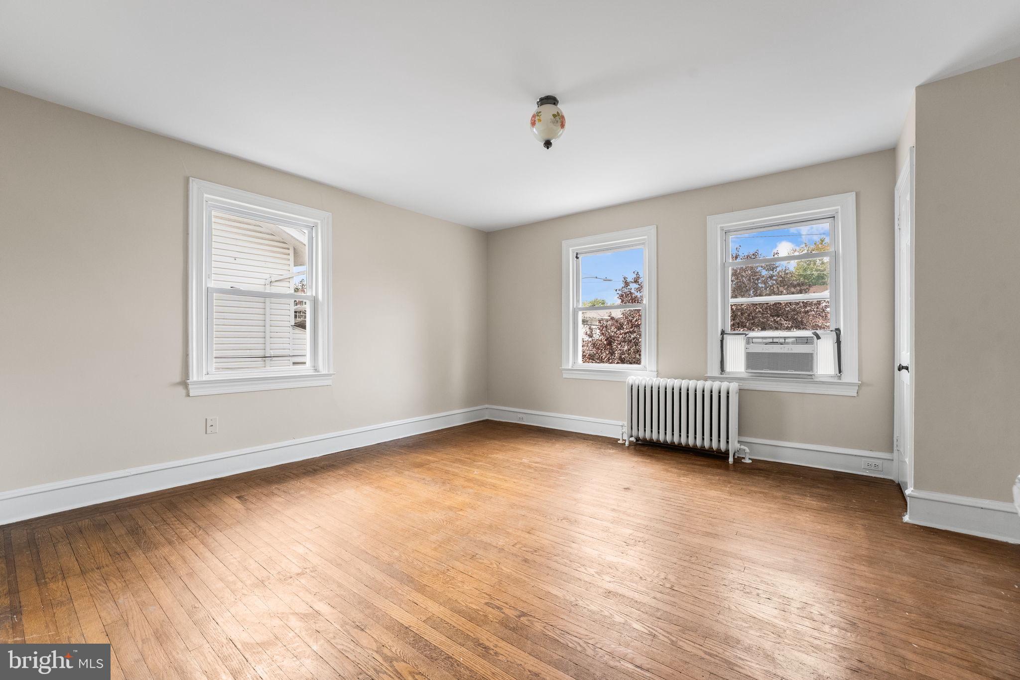 96 Drexel Avenue Lansdowne, PA 19050 - Photo 23 of 58 a view of an empty room with a window and wooden floor
