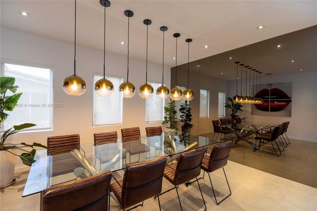 a kitchen with a table and chairs in it