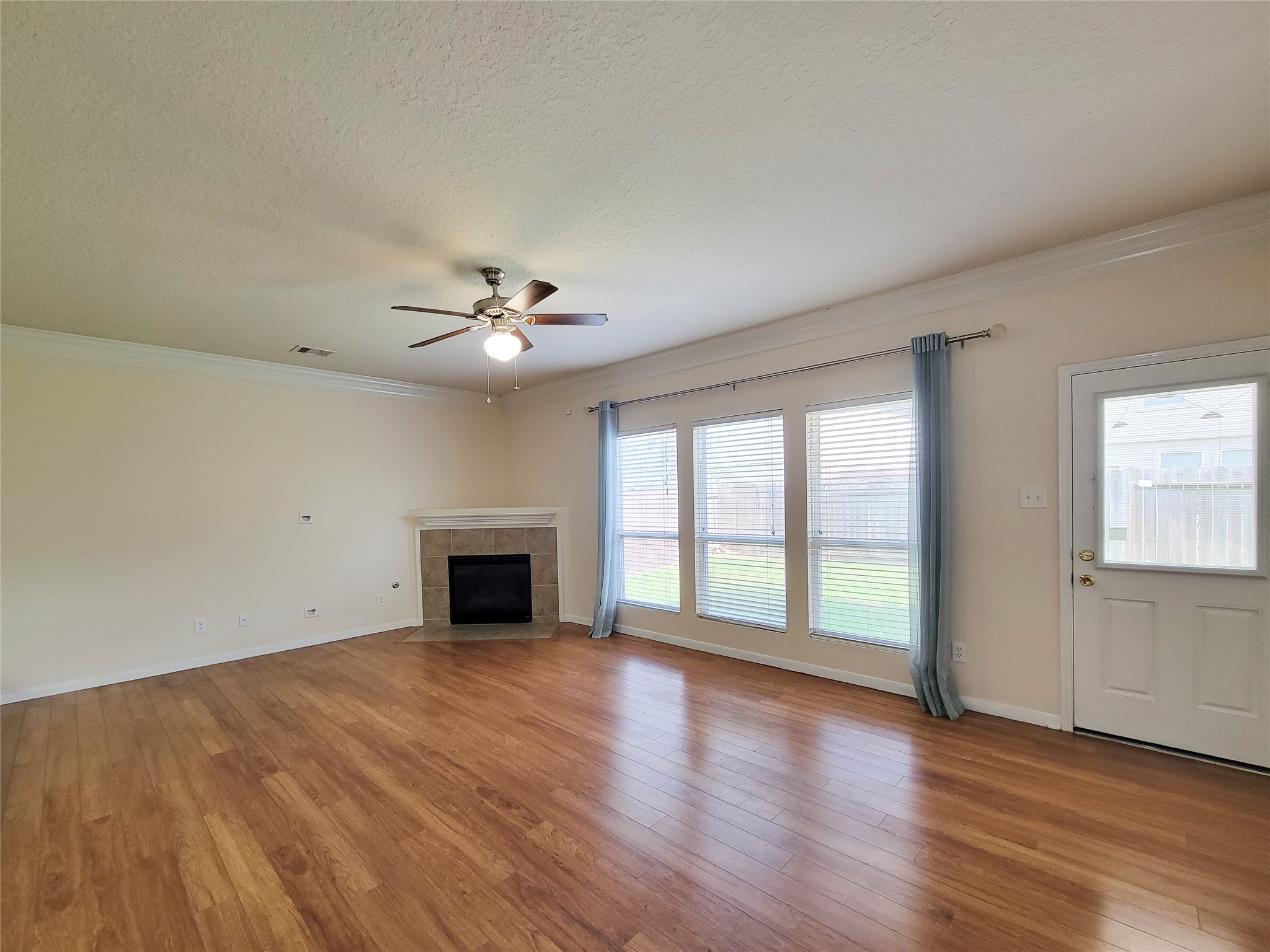 19626 Hardwood Ridge Trail Cypress, TX 77429 - Photo 12 of 48 Spacious Family room with easy upkeep laminated wood floor, crown molding & cozy Fireplace.
