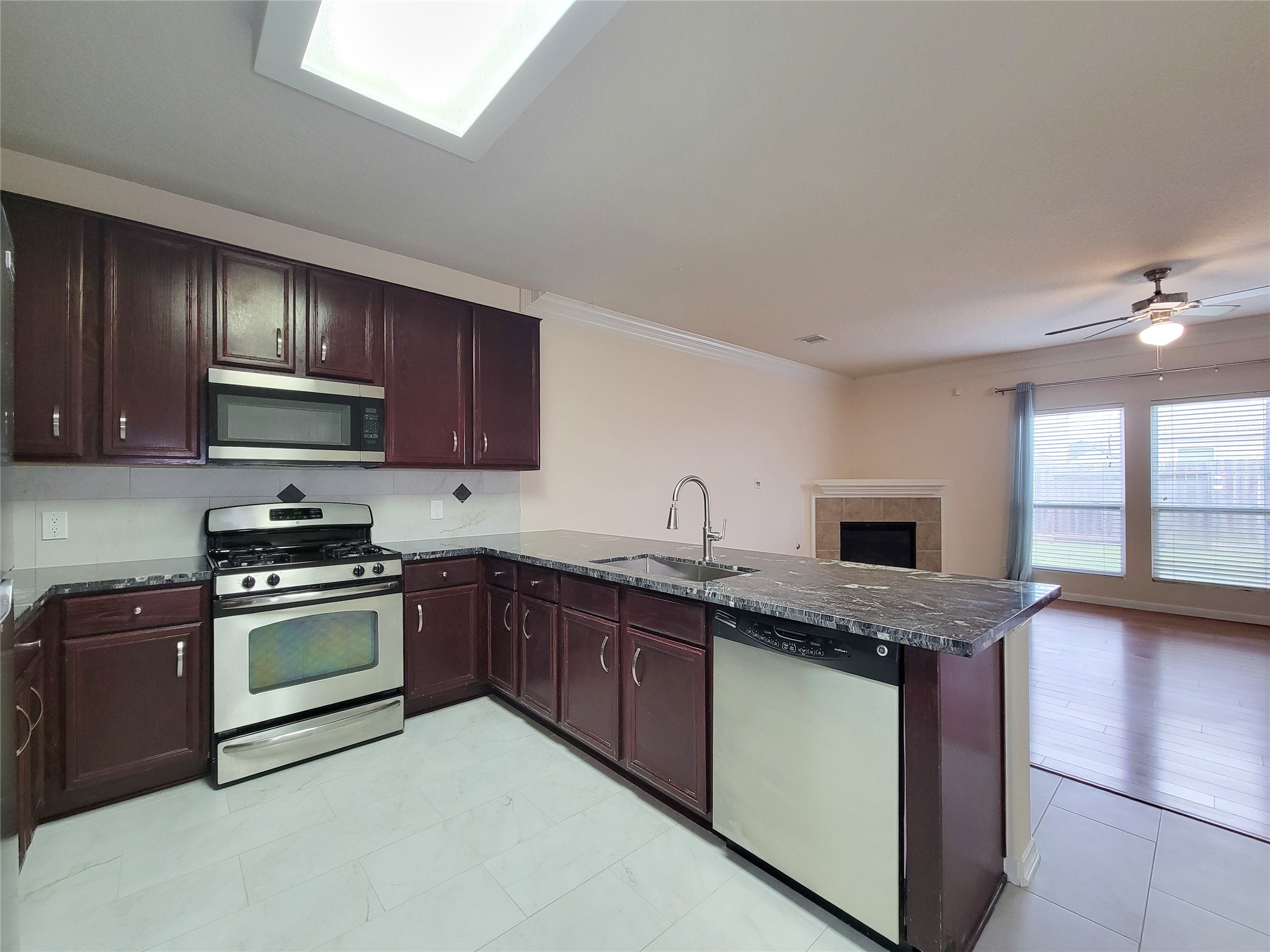 19626 Hardwood Ridge Trail Cypress, TX 77429 - Photo 7 of 48 Lovely Kitchen recently remodeled & updated with new Granite counters., stainless steel sink/faucet, Tile floor & matching back splash. Note the 42 inch cherry wood cabinets.