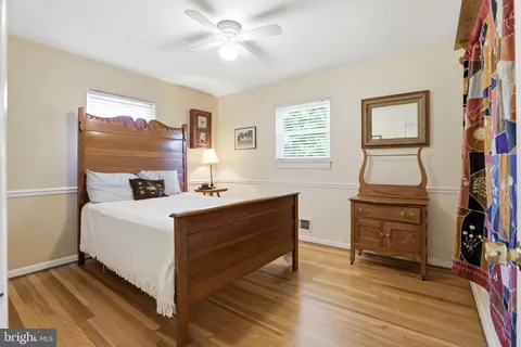 a bedroom with a bed and painting on the wall