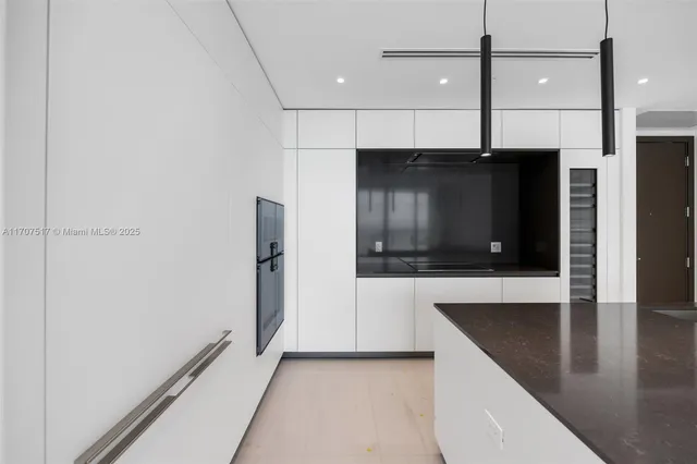 a view of a kitchen with a sink and cabinets