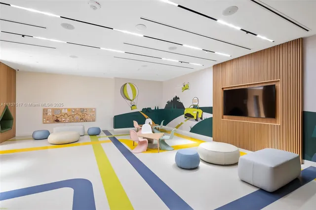 a front view of a building with a garden and plants