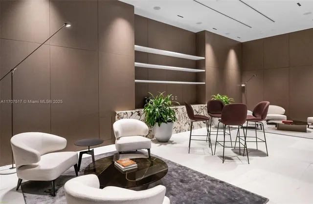 a living room with furniture and floor to ceiling window