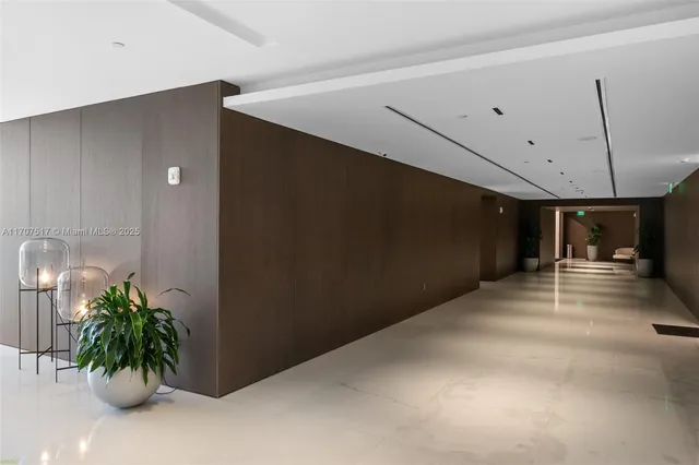 a view of a hallway with potted plants
