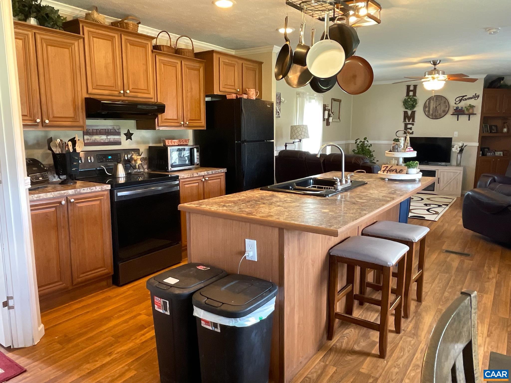 1619 South Constitution Route Dillwyn, VA 23936 - Photo 17 of 36 a kitchen with stainless steel appliances granite countertop a refrigerator a stove top oven a sink dishwasher and white cabinets with wooden floor