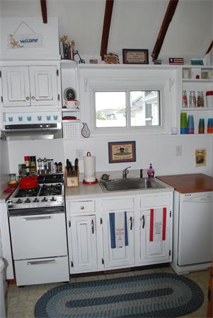 8 Warwick Road Gloucester, MA 01930 - Photo 3 of 11 a kitchen with stainless steel appliances granite countertop white cabinets and white stove