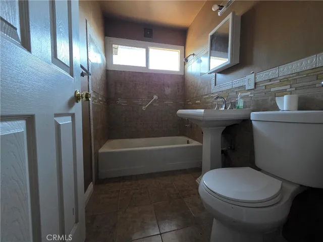 a bathroom with a sink a toilet and bathtub