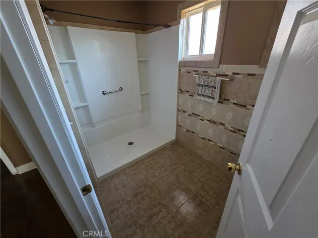 a bathroom with a shower and a sink