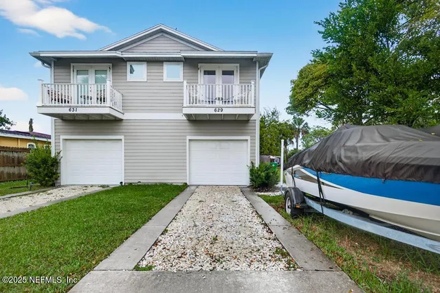 a front view of a house with a garden and yard