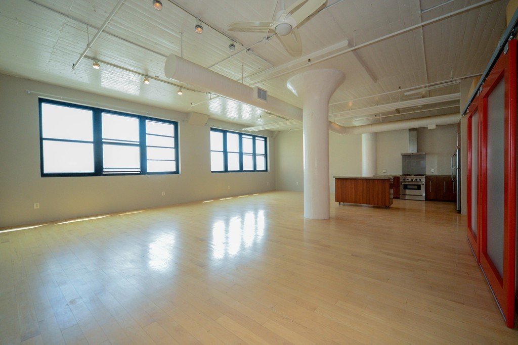 a view of livingroom with furniture wooden floor and windows
