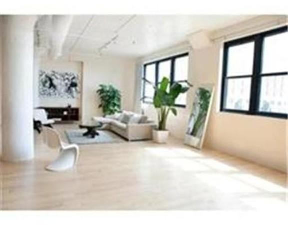 437 D Street, Unit 2C Boston, MA 02210 - Photo 11 of 13 a living room with furniture large window and potted plants