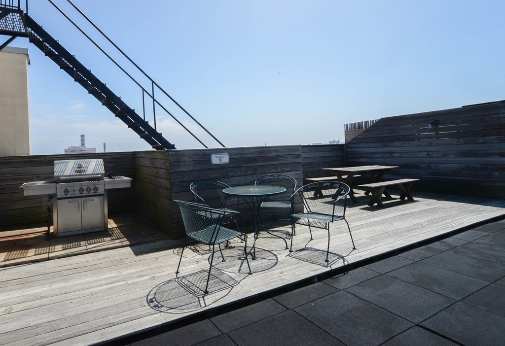 437 D Street, Unit 2C Boston, MA 02210 - Photo 13 of 13 a roof deck with table and chairs