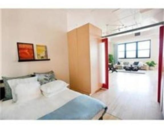 437 D Street, Unit 2C Boston, MA 02210 - Photo 6 of 13 a bedroom with a bed and a painting on the wall
