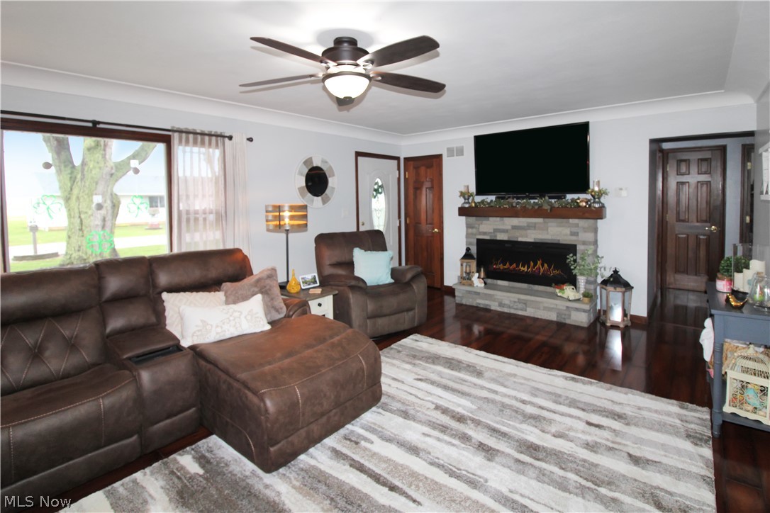 38 Meachem Road Port Clinton, OH 43452 - Photo 13 of 35 Living room with ornamental molding, a fireplace, dark wood-type flooring, and ceiling fan