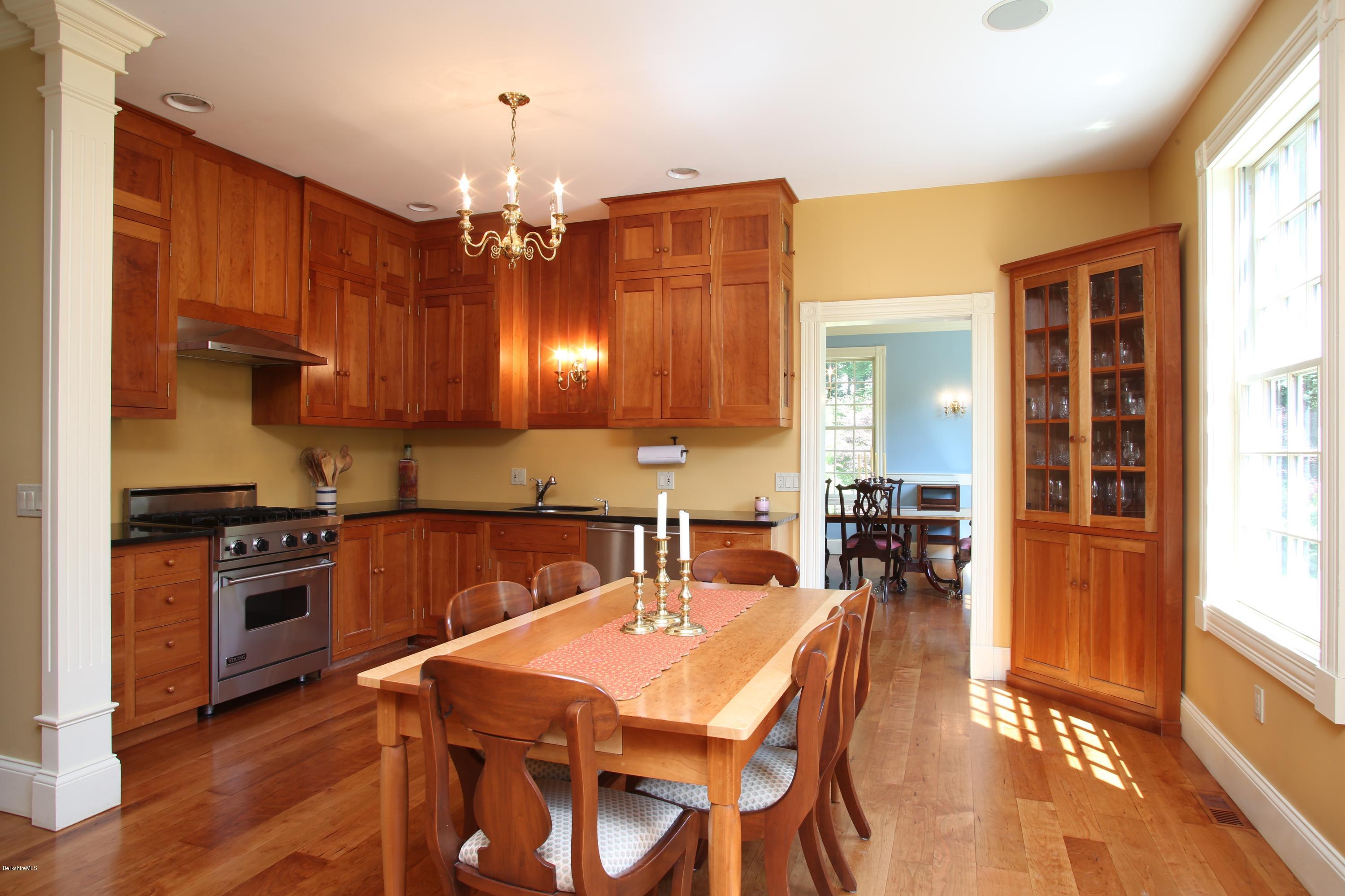 46 Stage Road Chesterfield, MA 01096 - Photo 11 of 34 a kitchen with stainless steel appliances wooden floor dining table and chairs