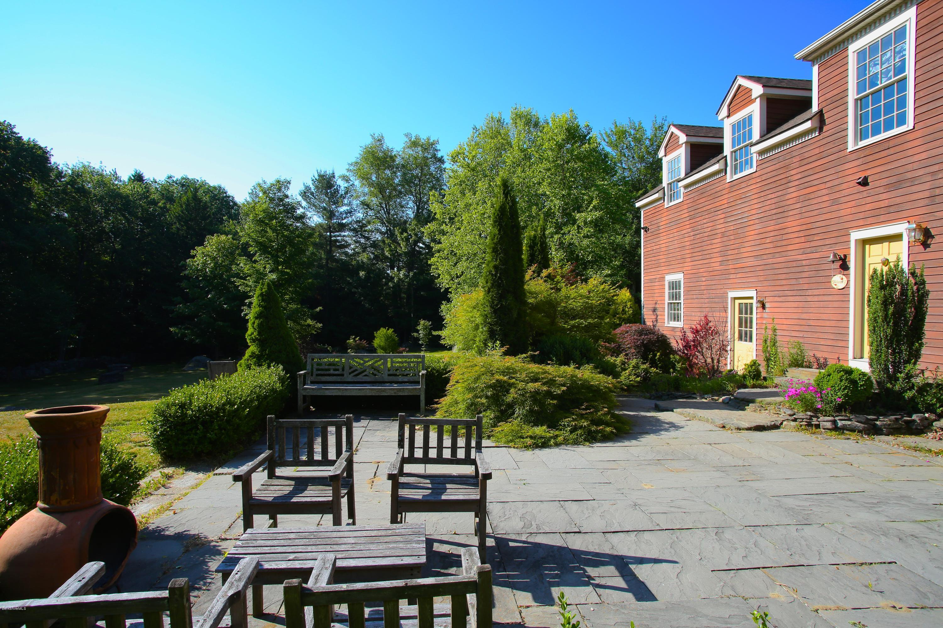 46 Stage Road Chesterfield, MA 01096 - Photo 7 of 34 a view of a patio with table and chairs potted plants and large tree