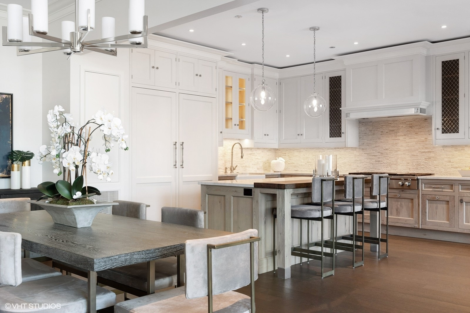 9 West Walton Street, Unit 1402 Chicago, IL 60610 - Photo 12 of 31 a kitchen with kitchen island a table and chairs in it