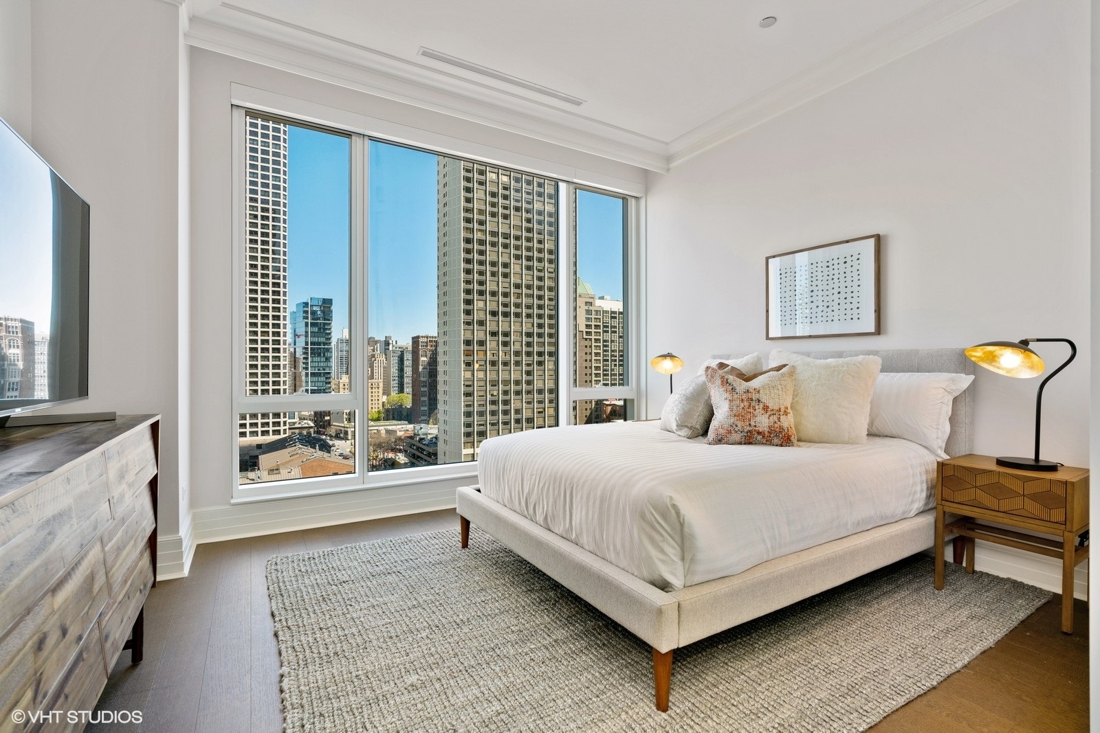9 West Walton Street, Unit 1402 Chicago, IL 60610 - Photo 19 of 31 a bedroom with a bed and a large window with outer view