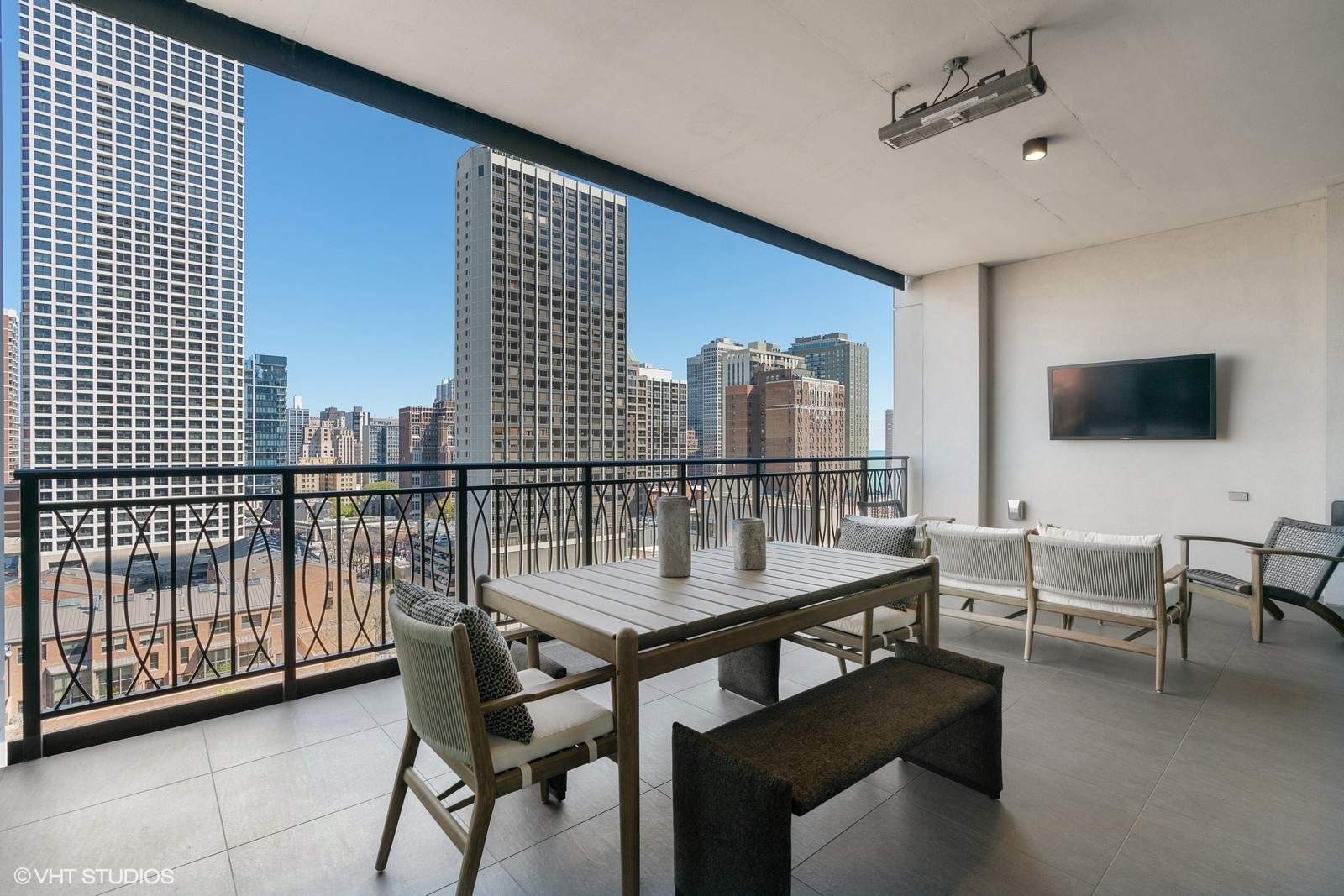 9 West Walton Street, Unit 1402 Chicago, IL 60610 - Photo 21 of 31 a dining room with furniture and a flat screen tv