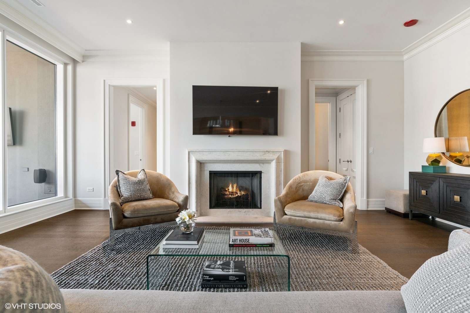 9 West Walton Street, Unit 1402 Chicago, IL 60610 - Photo 5 of 31 a living room with furniture a flat screen tv and a fireplace