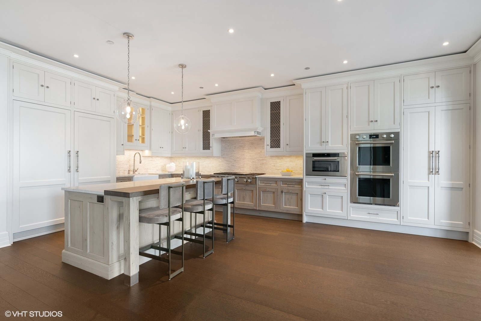 9 West Walton Street, Unit 1402 Chicago, IL 60610 - Photo 7 of 31 a kitchen with stainless steel appliances kitchen island granite countertop a table chairs sink and cabinets