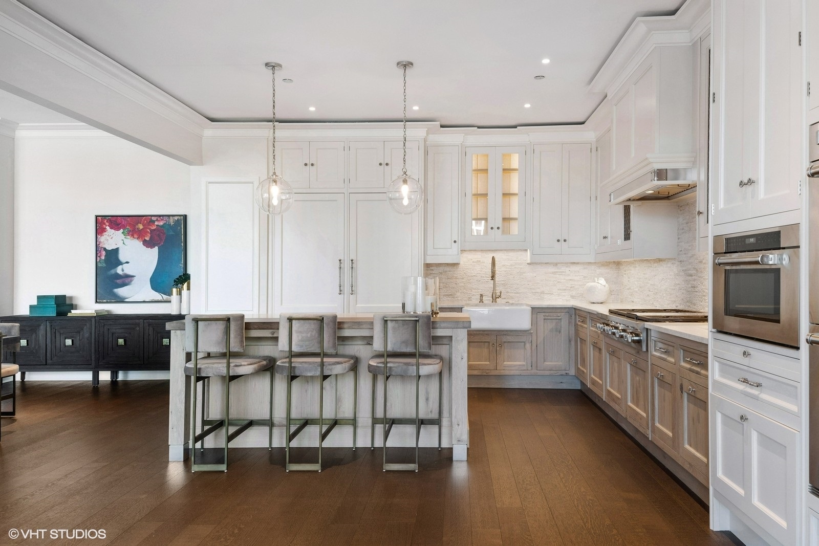 9 West Walton Street, Unit 1402 Chicago, IL 60610 - Photo 8 of 31 a kitchen with stainless steel appliances granite countertop a refrigerator a sink dishwasher a stove and a dining table with wooden floor