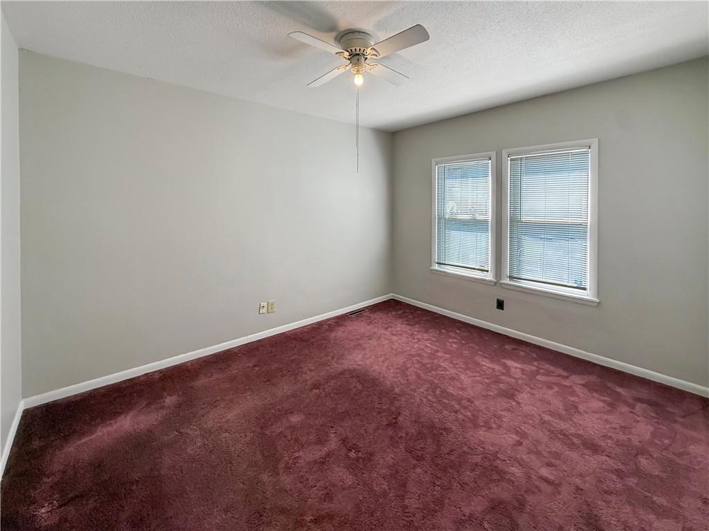 450 Clay Street Rochester, PA 15074 - Photo 15 of 34 an empty room with a chandelier fan and windows