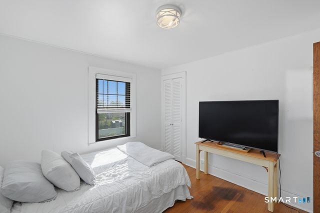 443 Highland Avenue Waterbury, CT 06708 - Photo 13 of 24 a bedroom with a bed and a flat screen tv