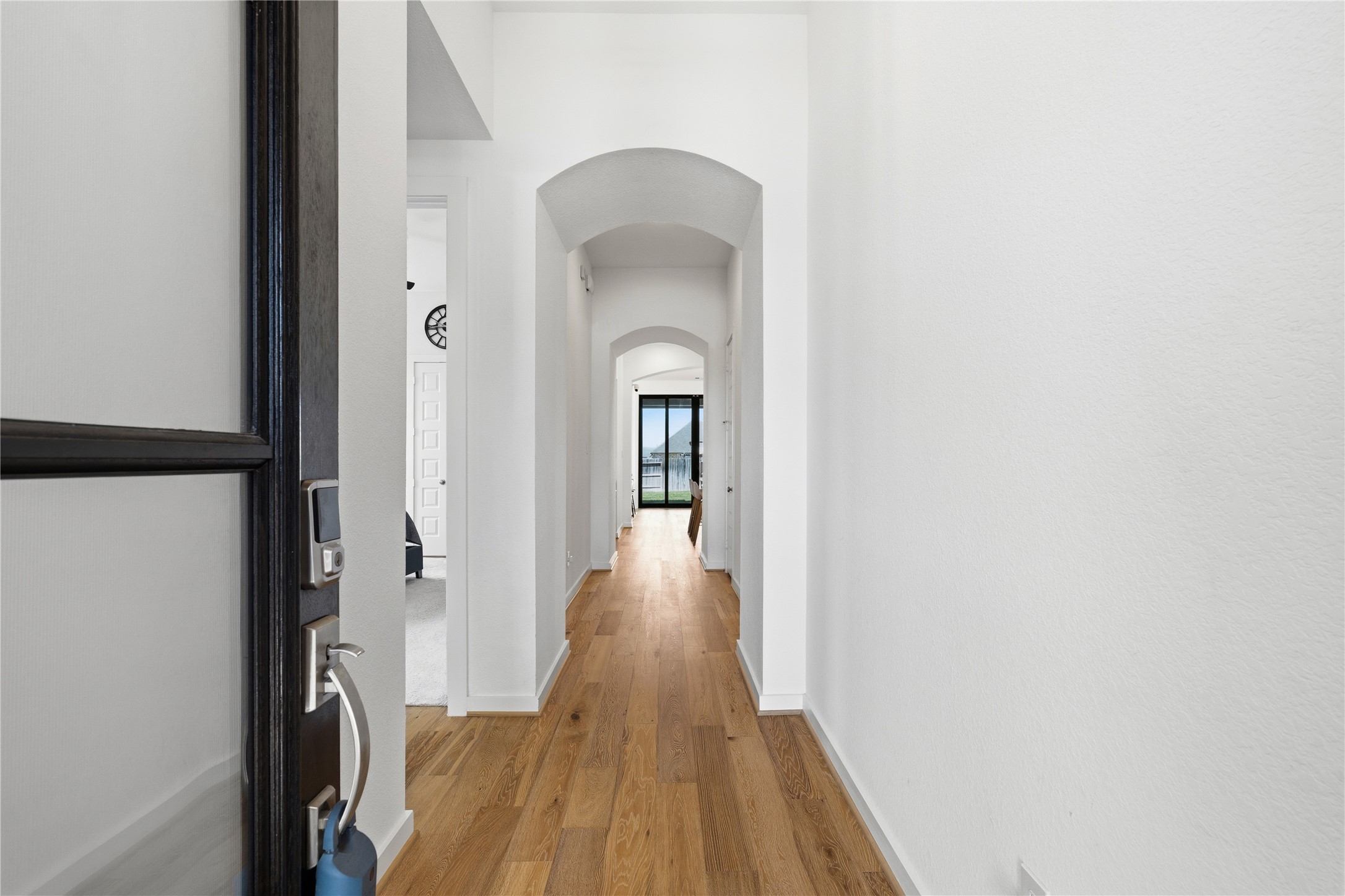 416 Bartlett Street Webster, TX 77598 - Photo 3 of 49 Grand entry hallway with arched doorways and wood-look flooring