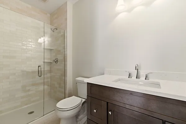 a bathroom with a sink toilet and shower