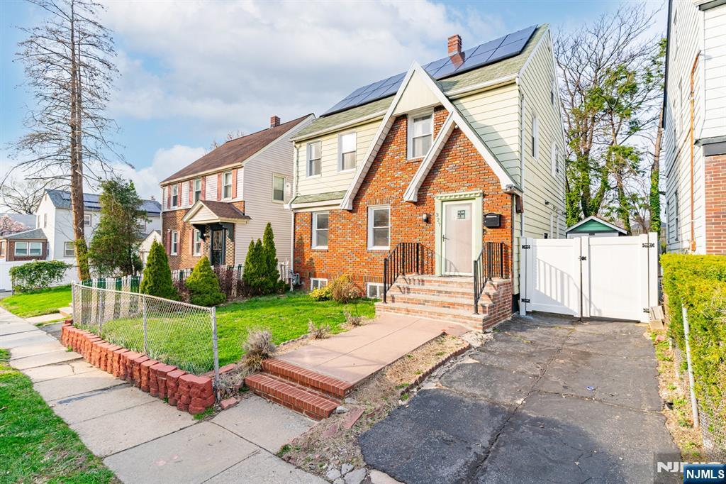 327 Field Place Hillside, NJ 07205 - Photo 13 of 18 a view of a house with a yard and a park